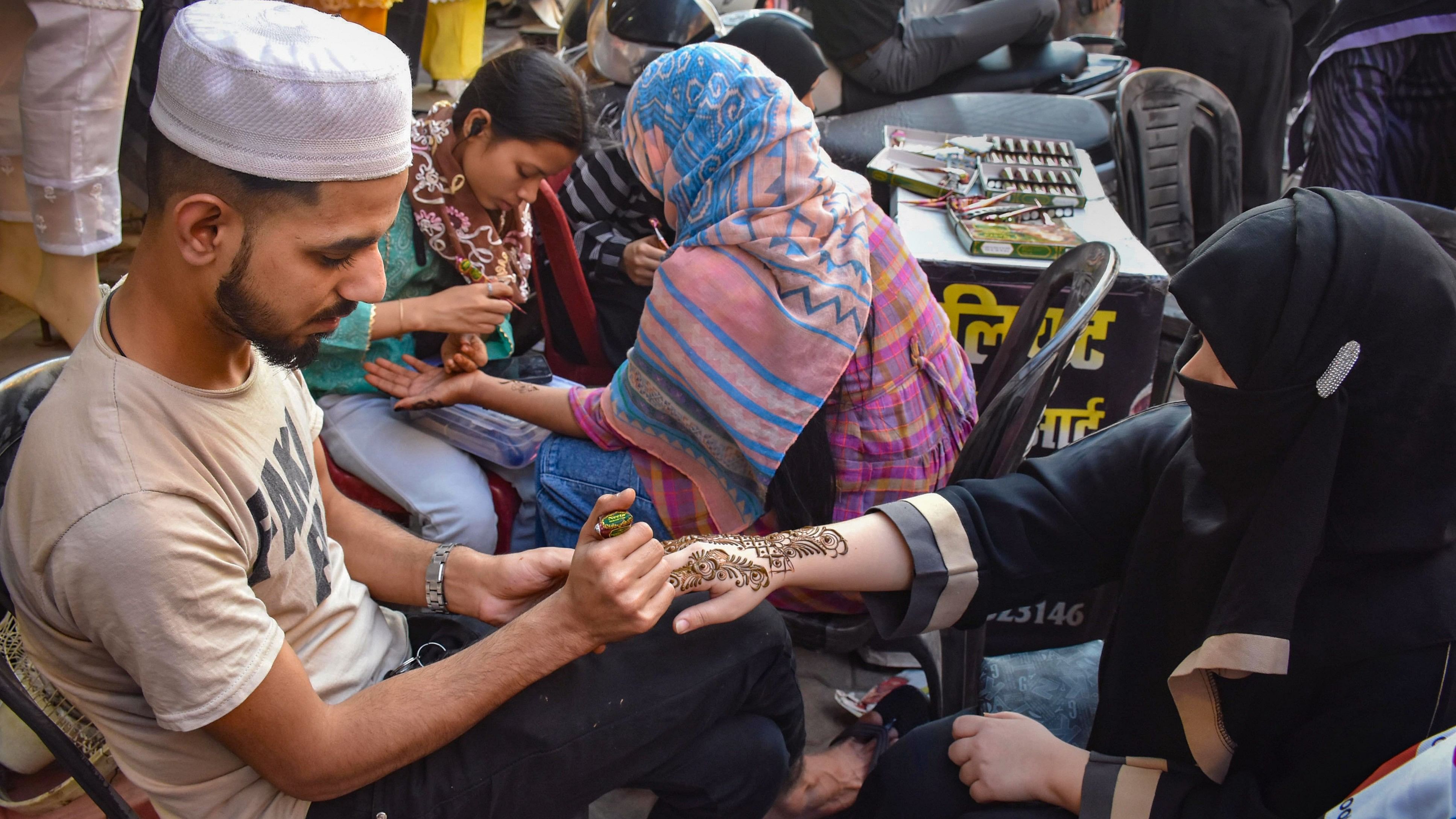 <div class="paragraphs"><p>Muslim women get their hands decorated with henna ahead of Eid-ul-Azha celebrations.</p></div>