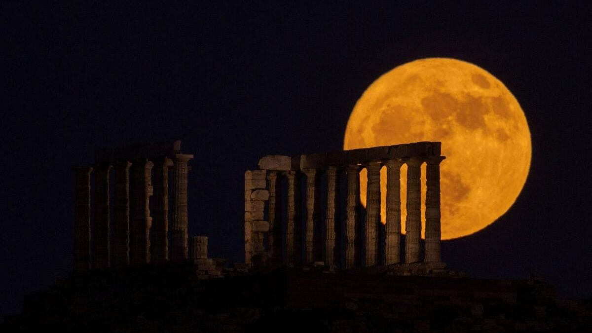 <div class="paragraphs"><p>The Strawberry Moon rises behind the Temple of Poseidon on Cape Sounion, Greece, June 21, 2024. </p></div>