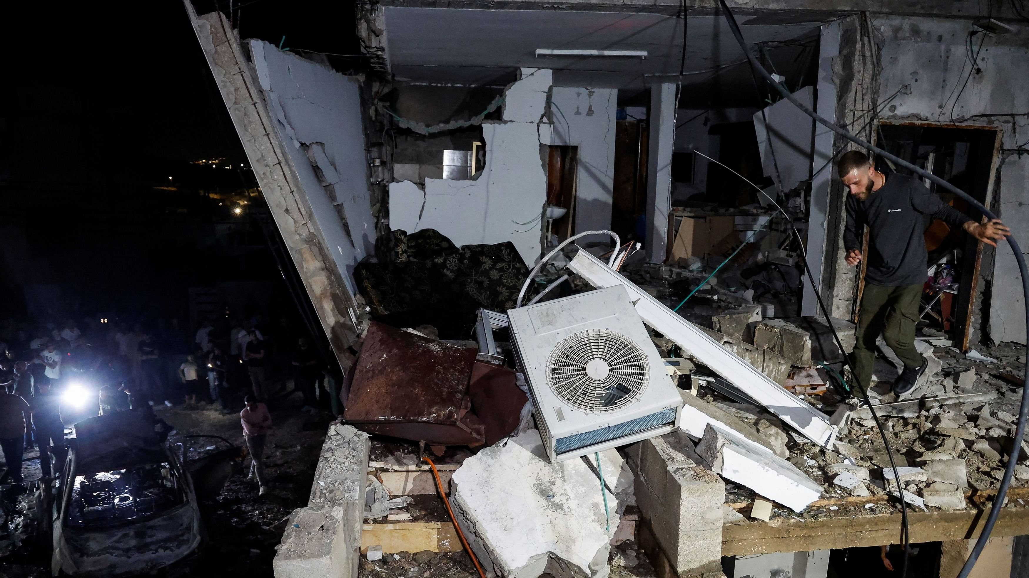 <div class="paragraphs"><p>A man walks in a damaged building targeted by Israeli forces during a raid in which Palestinians were killed, in Kafr Dan, near Jenin, in the Israeli-occupied West Bank.</p></div>