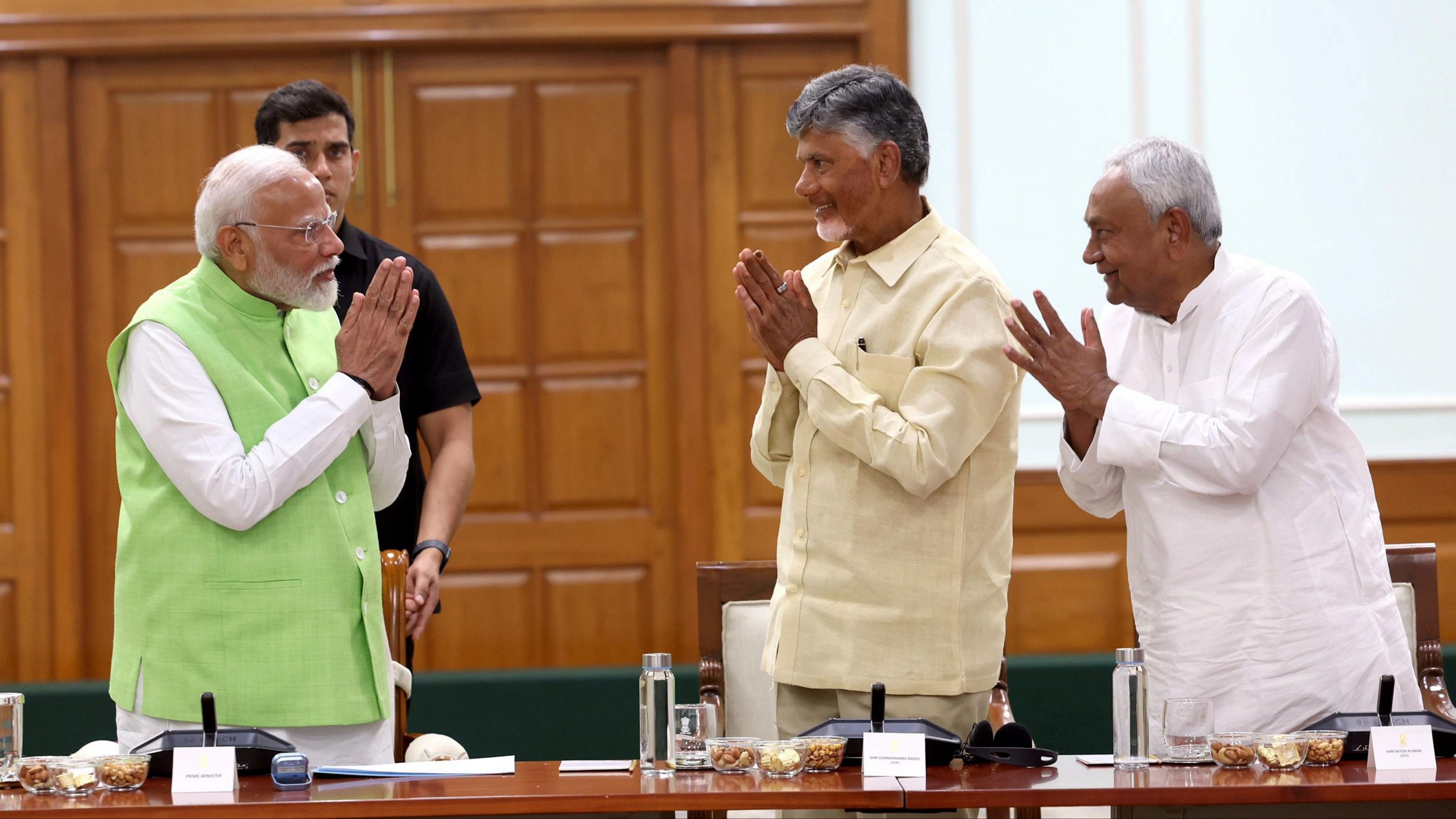 <div class="paragraphs"><p>Prime Minister Narendra Modi with TDP chief N Chandrababu Naidu and JD(U) chief Nitish Kumar during National Democratic Alliance (NDA) meeting at PM's residence, in New Delhi, on Wednesday.</p></div>