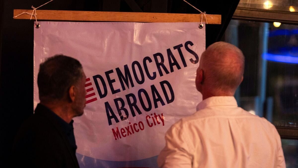 <div class="paragraphs"><p>People observe the sign of the Democrats Abroad organization during the first debate between US President Joe Biden and former President Donald Trump, at the Pinche Gringo BBQ restaurant, in Mexico City.</p></div>