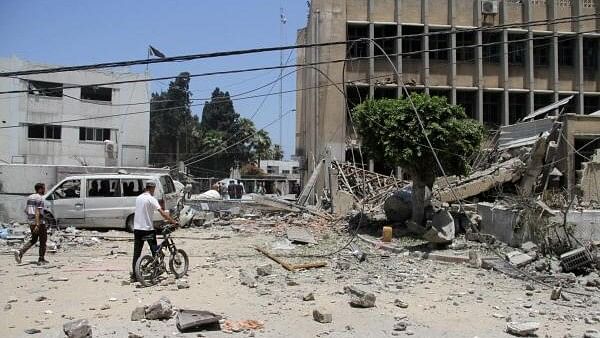 <div class="paragraphs"><p>Palestinians search for casualties outside the headquarters of UNRWA (United Nations Relief and Works Agency) following an Israeli strike, amid the Israel-Hamas conflict, in Gaza City, June 23, 2024.</p></div>