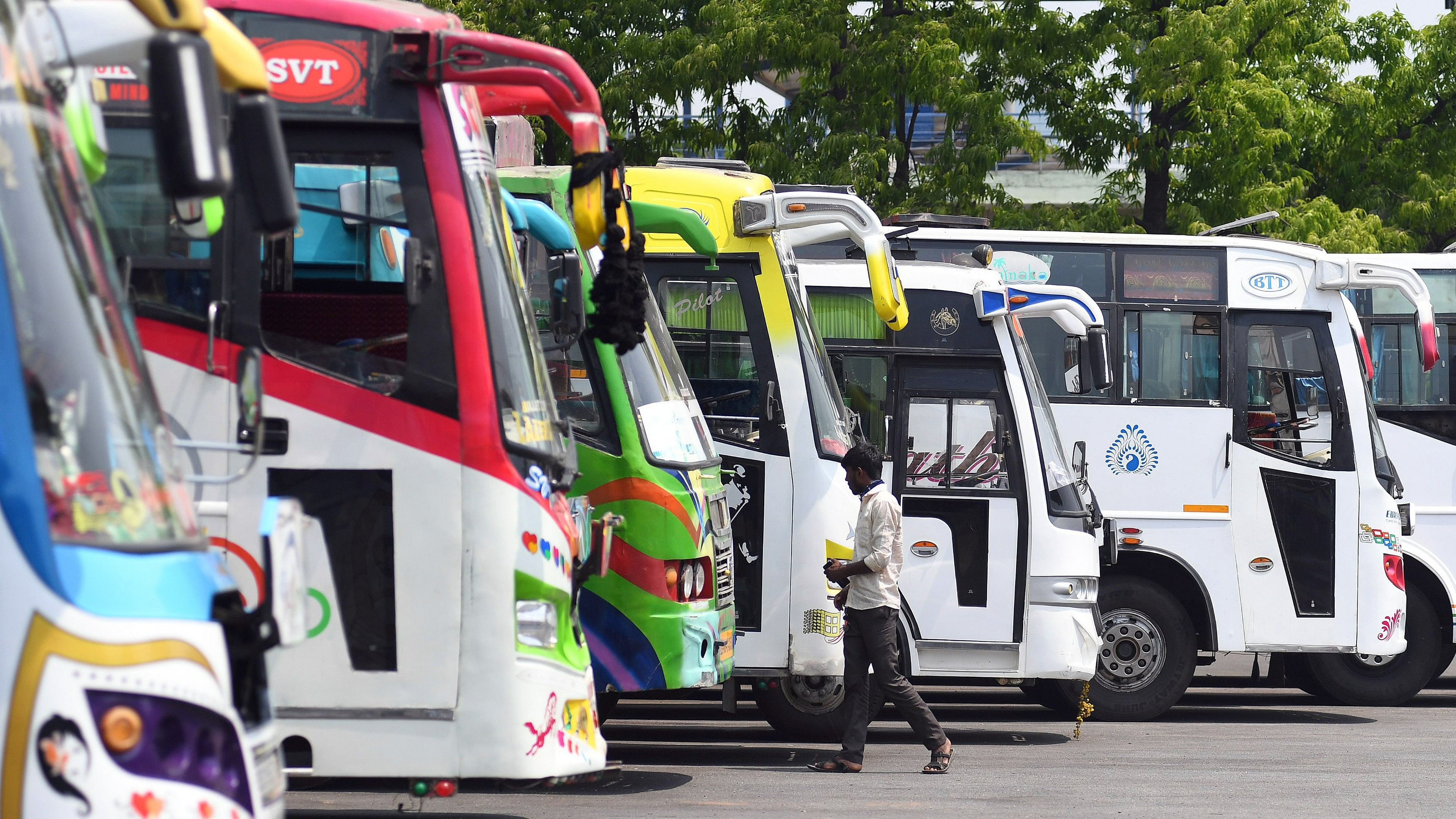 <div class="paragraphs"><p>Passengers wait to board private buses during the indefinite strike called by RTC workers, at Kempegowda Bus Stand, Majestic in Bengaluru on Friday, April 09, 2021.</p></div>