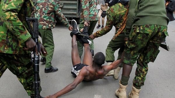 <div class="paragraphs"><p>Police officers detain a man during a demonstration over police killings of people protesting against Kenya's proposed finance bill 2024/2025, in Nairobi, Kenya.</p></div>