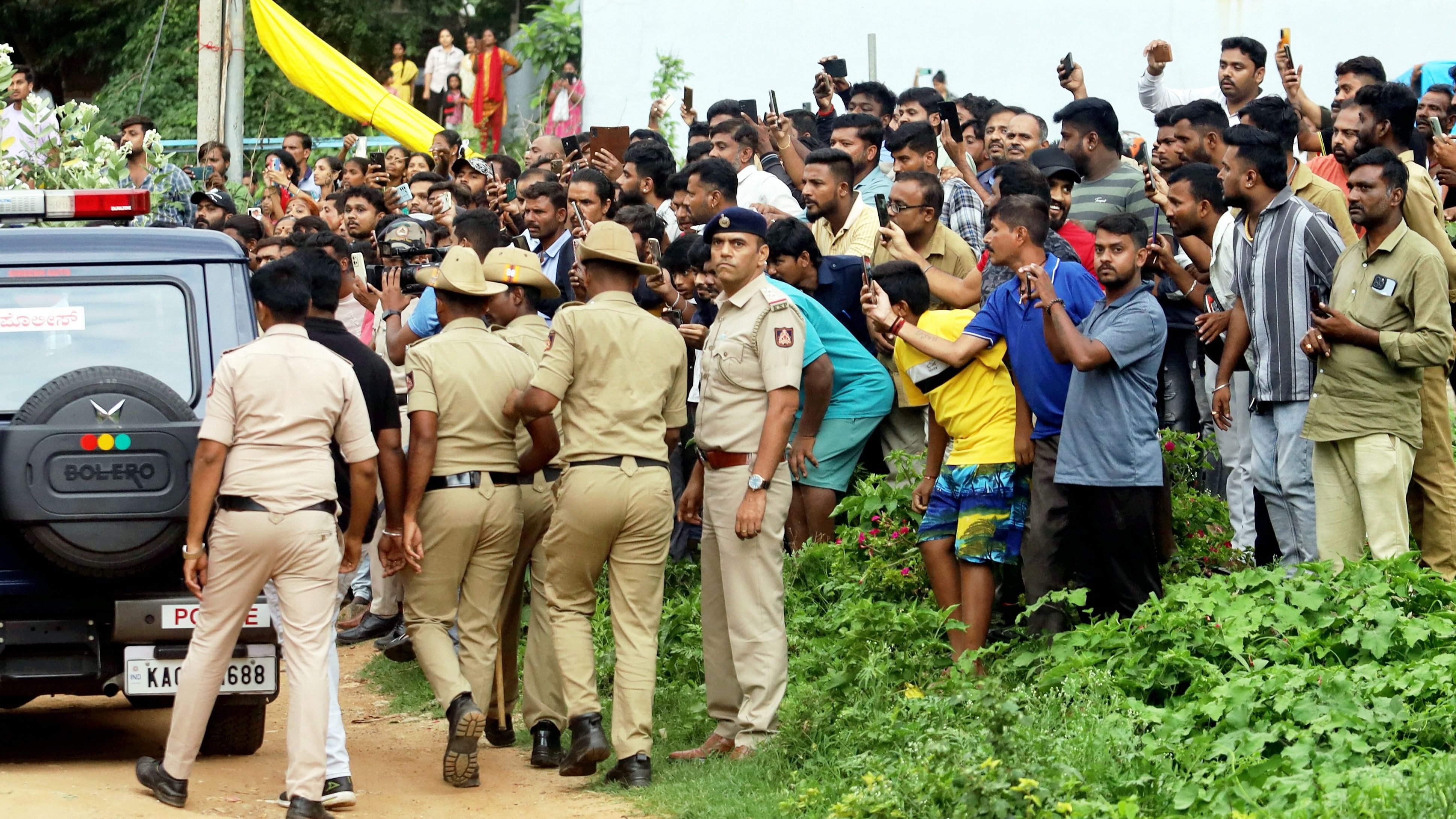 <div class="paragraphs"><p>Locals gather as the accused in the Renukaswamy murder case, being brought to the crime scene for investigation.</p></div>