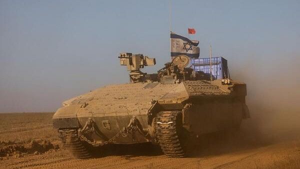 <div class="paragraphs"><p>An Israeli APC manoeuvres near the Israel-Gaza border</p></div>