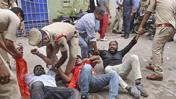 <div class="paragraphs"><p>Police personnel detain activists of the NSUI and Left-backed student unions during their protest demanding reconducting the medical entrance exam NEET, at the residence of Union Minister G Kishan Reddy, in Hyderabad, Saturday, June 22</p></div>