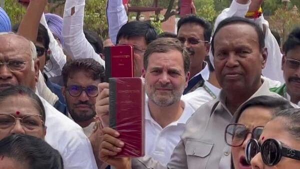 <div class="paragraphs"><p>Congress leader Rahul Gandhi and other INDIA bloc leaders show copies of the Constitution of India during their protest at the Parliament House complex on the first day of the first session of the 18th Lok Sabha, in New Delhi, Monday.&nbsp;</p></div>