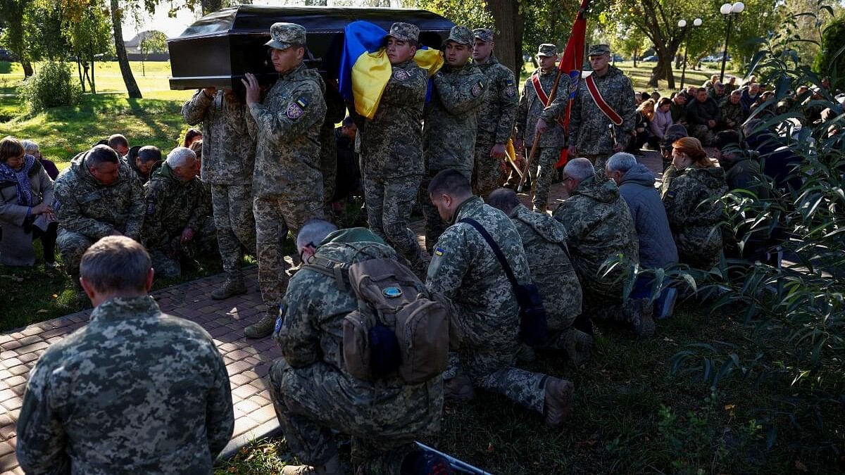 <div class="paragraphs"><p>Ukrainian service members carry a coffin with the body of their brother-in-arms, a battalion commander who was killed in a fight against Russian troops, amid Russia's attack on Ukraine, during a funeral ceremony in  Ukraine.</p></div>