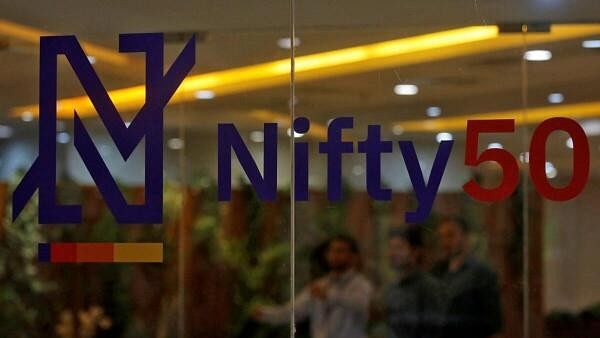 <div class="paragraphs"><p>People walk past a new brand identity for Nifty Indices inside the National Stock Exchange building in Mumbai</p></div>