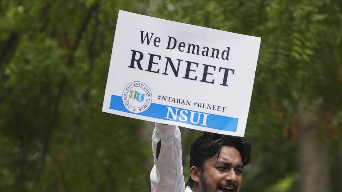 <div class="paragraphs"><p>An NSUI activist holds a placard during a protest against NEET paper leak. (Representative image)</p></div>