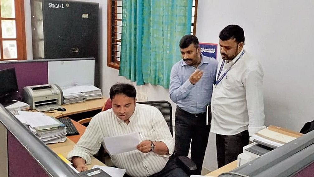 <div class="paragraphs"><p>DC Dr K V Rajendra checks the files during a surprise visit to taluk office in Mysuru on Thursday. </p></div>