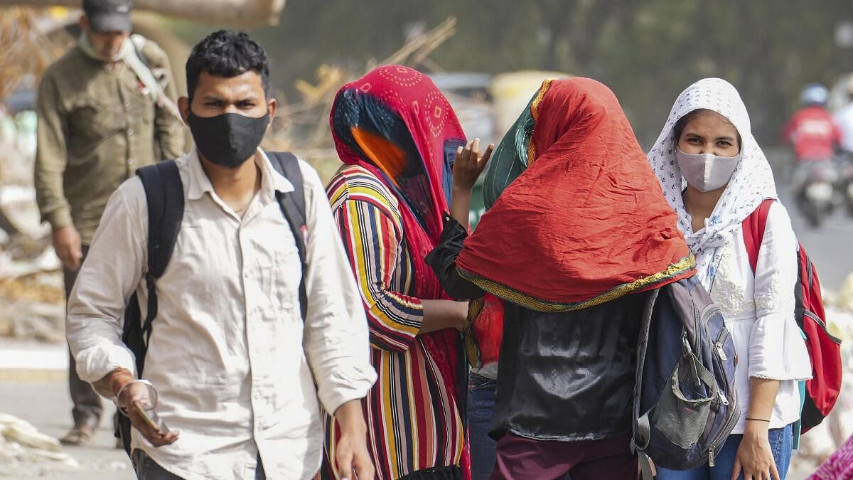 <div class="paragraphs"><p>People cover their faces for protection from the scorching heat on a hot summer day, in New Delhi.</p></div>