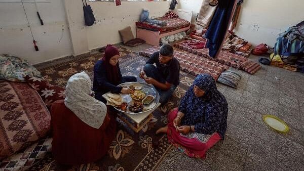 <div class="paragraphs"><p>A Palestinian family eats breakfast as they shelter at a UNRWA school in Khan Younis, in the southern Gaza Strip, June 16, 2024.</p></div>