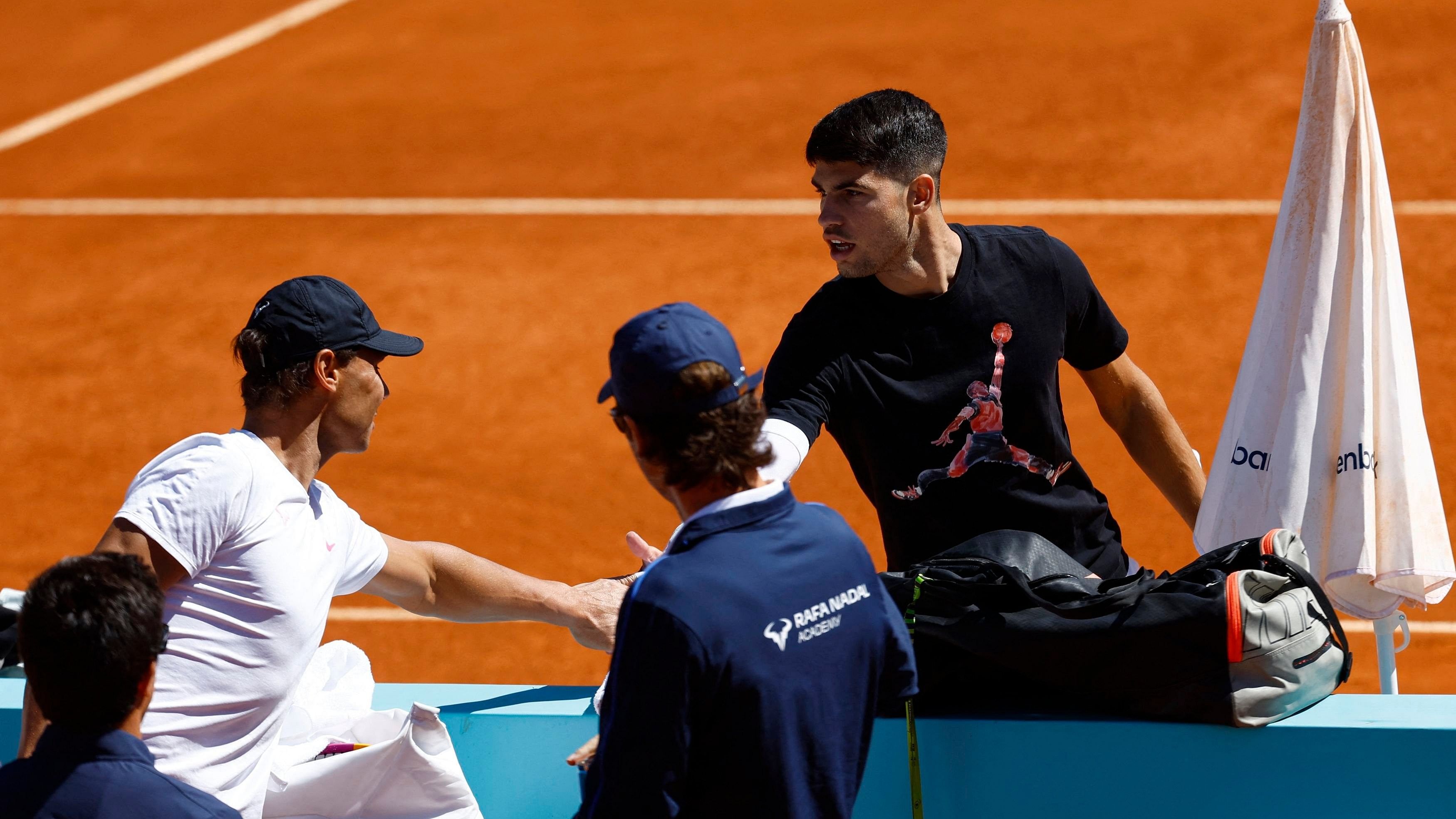 <div class="paragraphs"><p>File photo: Spain's Carlos Alcaraz(R) shakes hands with Rafael Nadal during practice.</p></div>