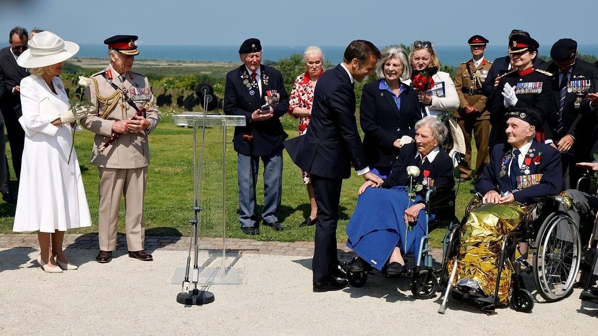 <div class="paragraphs"><p>France President Emmanuel Macron reacts after awarding 104-years-old British World War II veteran Christian Lamb, who helped to plan the D-Day landings in Normandy, with the insignia of Knight in the Legion of Honour order, as Britain's Queen Camilla and Britain's King Charles III look on during the commemorative ceremony marking the 80th anniversary of the World War II "D-Day" Allied landings in Normandy, at the World War II British Normandy Memorial near the village of Ver-sur-Mer which overlooks Gold Beach and Juno Beach in northwestern France, on June 6, 2024. </p></div>