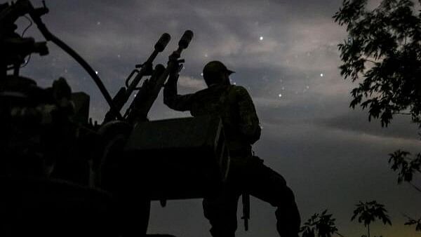 <div class="paragraphs"><p>A Ukrainian serviceman from an anti-drone mobile air defence unit stands near an anti aircraft cannon as he waits for Russian kamikaze drones in Kherson region</p></div>