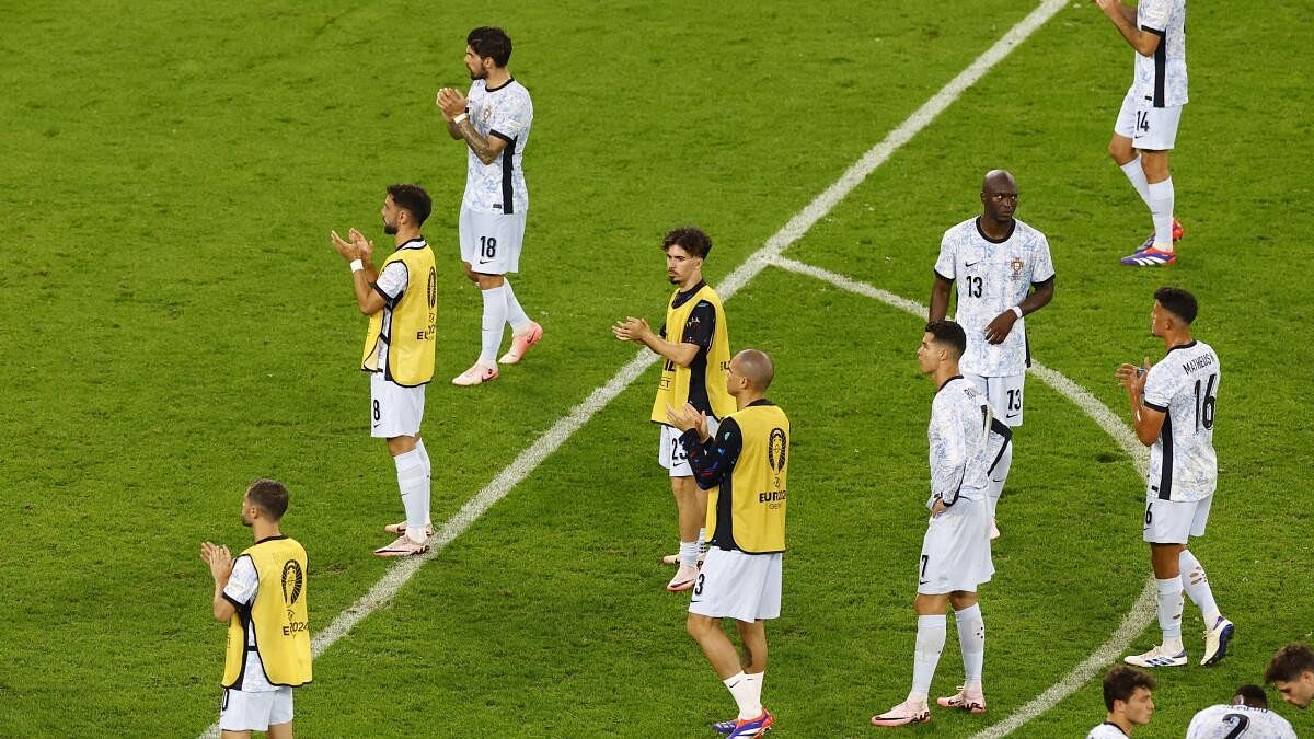 <div class="paragraphs"><p>Portugal players applaud their fans after the match.</p></div>