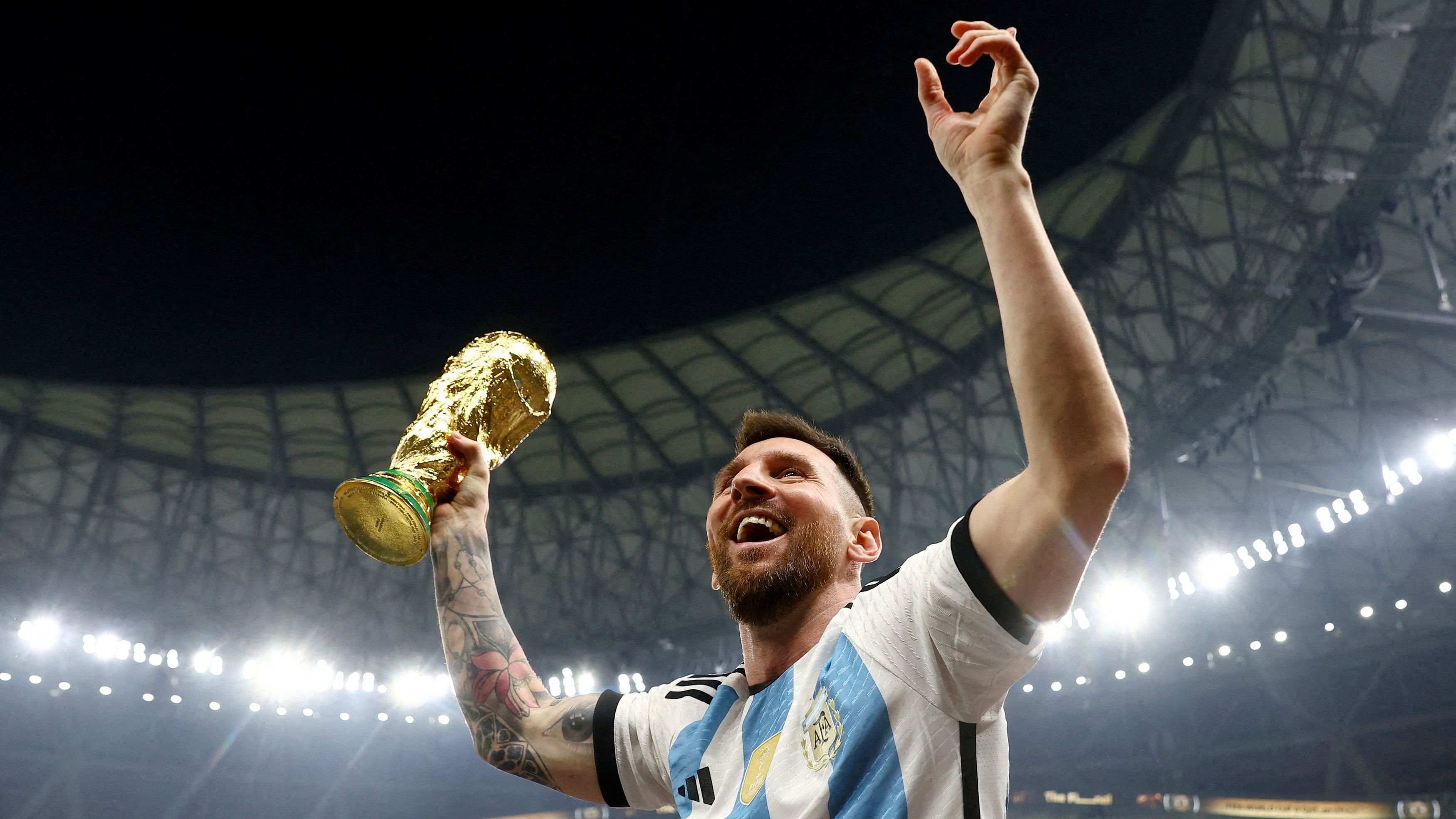 <div class="paragraphs"><p>   Lionel Messi celebrates with the Qatar 2022 FIFA World Cup trophy on December 18, 2022.</p></div>