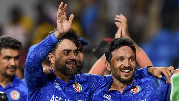 <div class="paragraphs"><p>Afghanistan's captain Rashid Khan with teammate Gulbadin Naib acknowledges fans after Afghanistan won the ICC Men's T20 World Cup cricket match against Bangladesh</p></div>