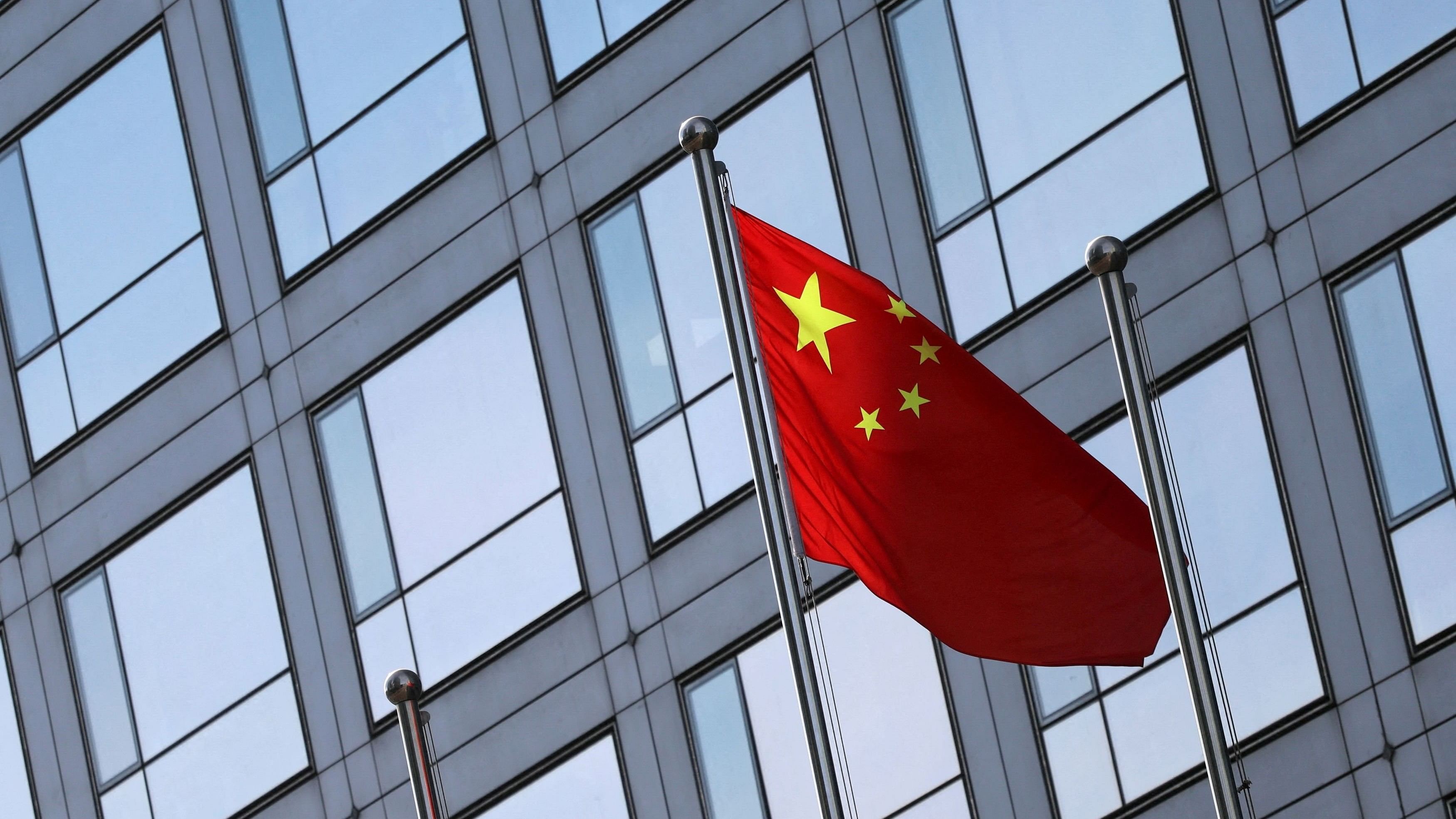 <div class="paragraphs"><p> A Chinese flag flutters outside the China Securities Regulatory Commission  building.&nbsp;</p></div>