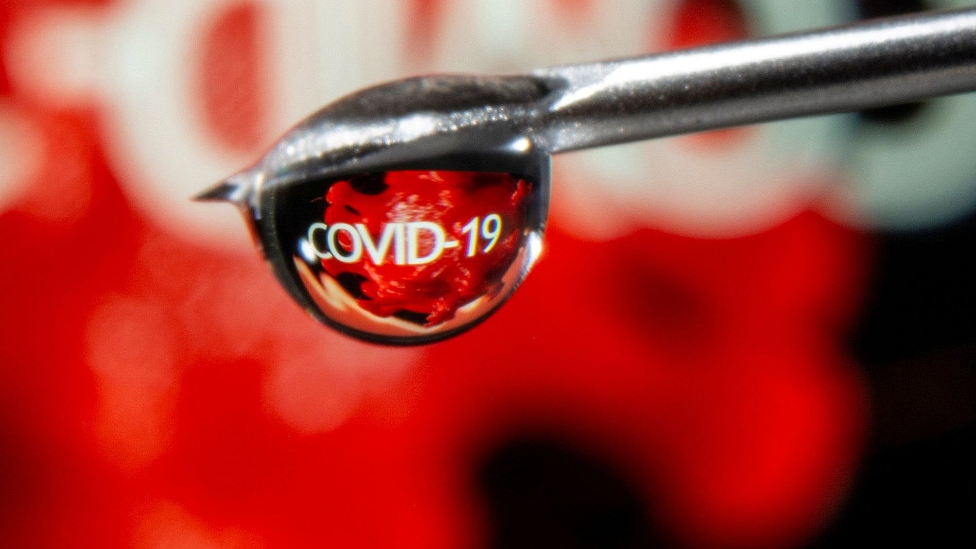 <div class="paragraphs"><p>The word "Covid-19" is reflected in a drop on a syringe needle in this illustration taken November 9, 2020. </p></div>