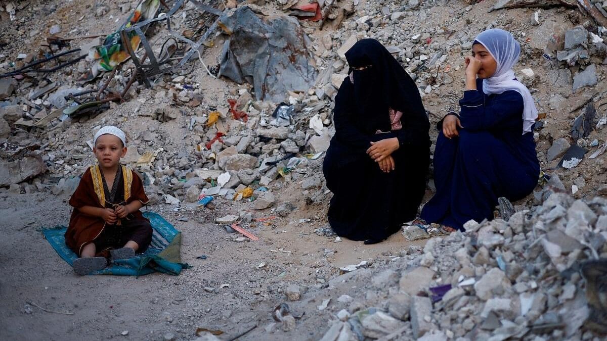 <div class="paragraphs"><p>Palestinians attend Eid al-Adha prayers by the ruins of al-Al Rahma mosque destroyed by Israeli air strikes, amid the Israel-Hamas conflict, in Khan Younis, in the southern Gaza Strip, June 16, 2024.</p></div>