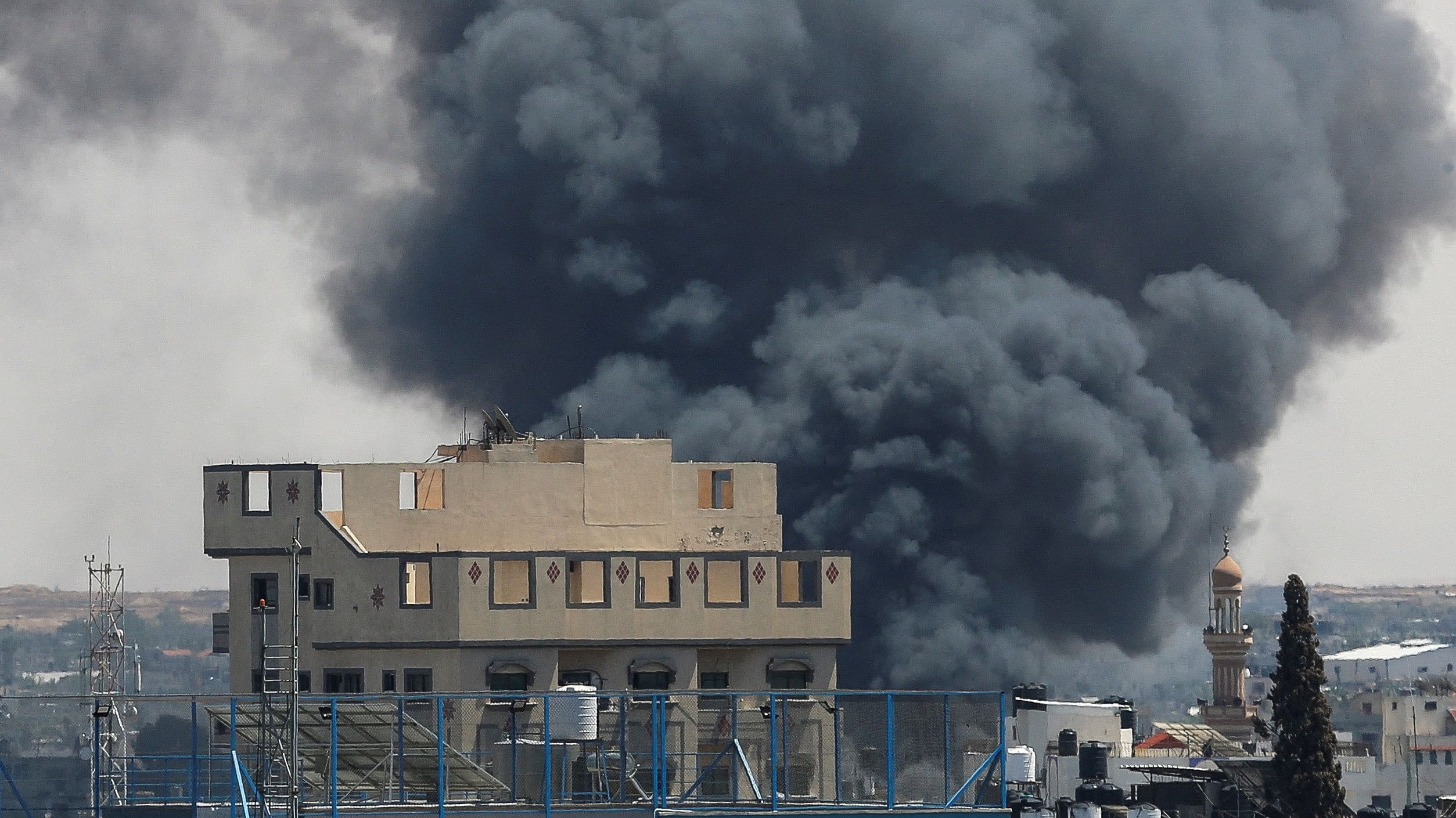 <div class="paragraphs"><p>Smoke billows from a building in Rafah.</p></div>