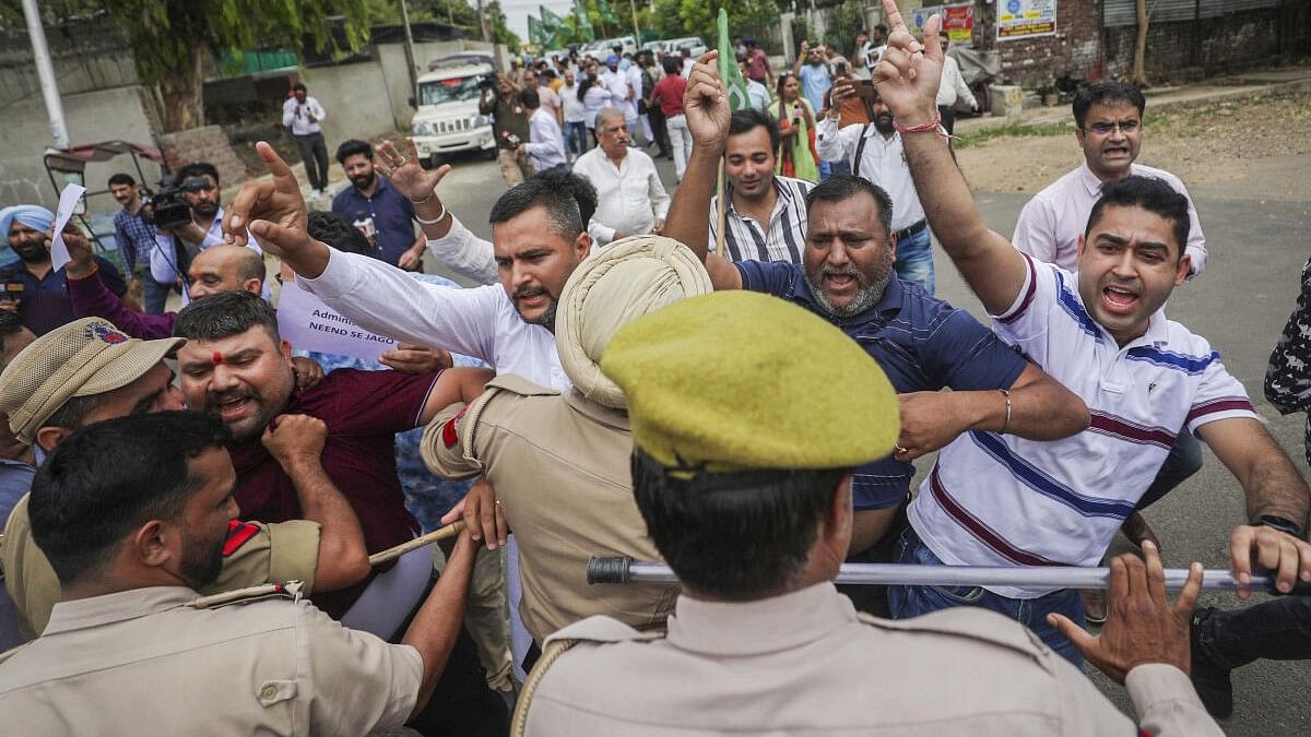 <div class="paragraphs"><p>Police personnel try to stop PDP workers protesting over the recent terror attacks in Jammu on Friday.</p></div>