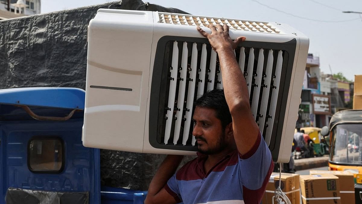 <div class="paragraphs"><p>A worker carries an air cooler for delivery to a customer during the heat wave in Ahmedabad.</p></div>