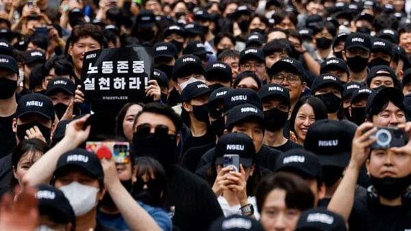 <div class="paragraphs"><p>A member of the National Samsung Electronics Union (NSEU) holds a placard that reads "Respect labour" in front of the Samsung Electronics Seocho Building in Seoul, South Korea,.</p></div>