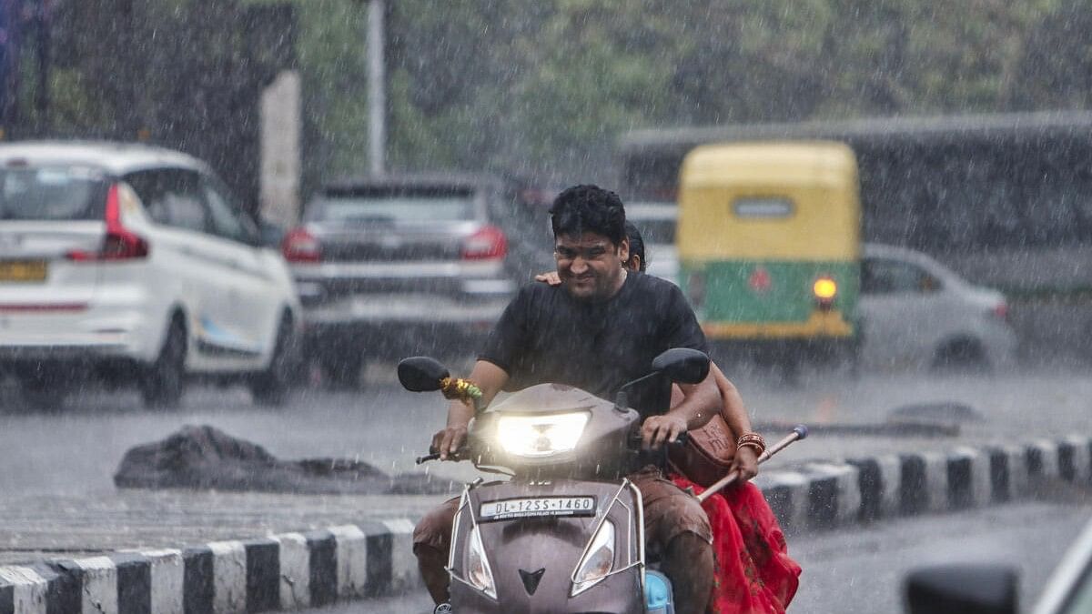 <div class="paragraphs"><p>A couple rides amid heavy rains in Delhi. (Representative image)</p></div>