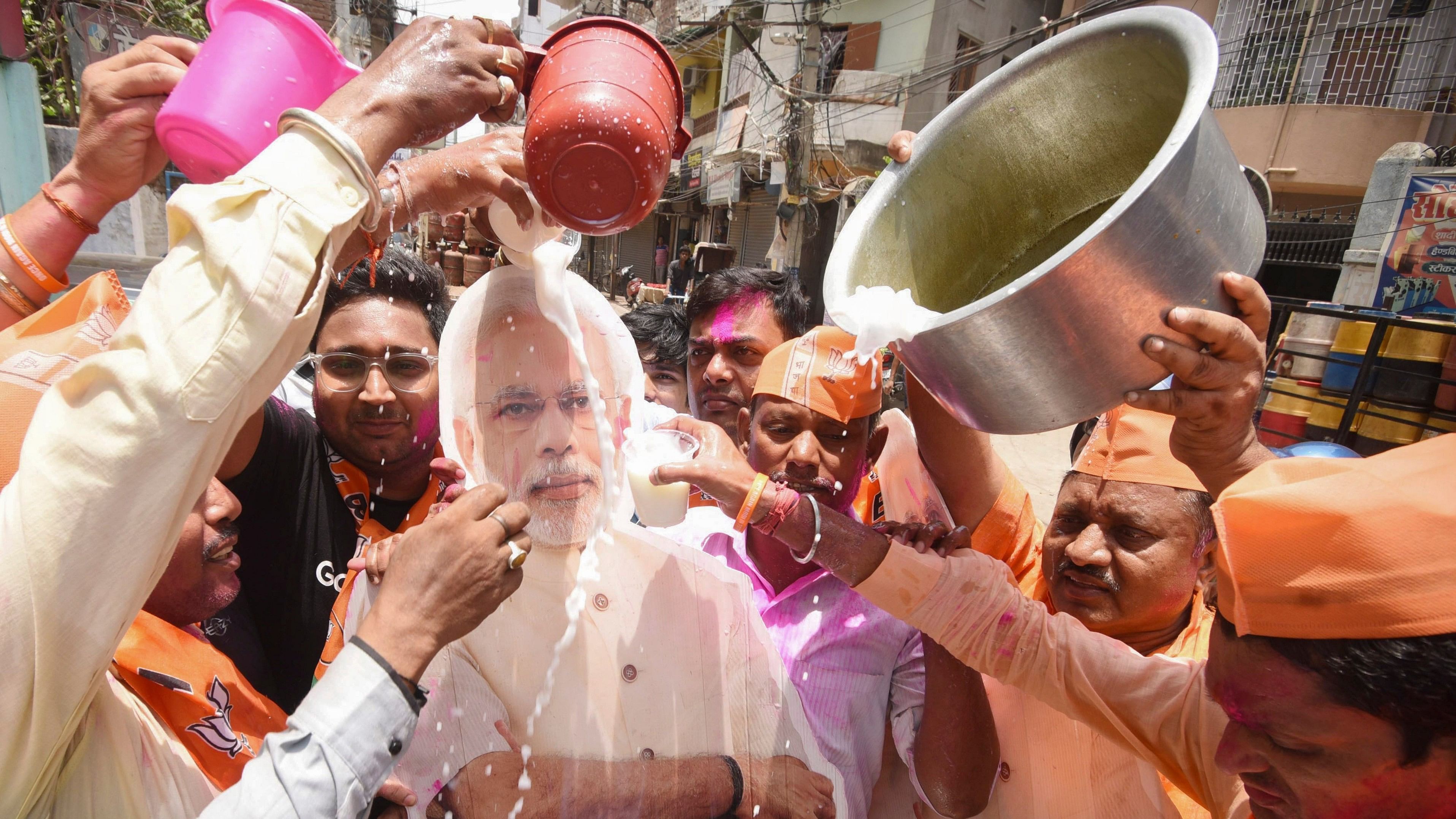 <div class="paragraphs"><p>Supporters pour milk on a poster of Narendra Modi before&nbsp; his swearing-in ceremony for a 3rd consecutive term, in Patna on Sunday, June 9, 2024. </p></div>