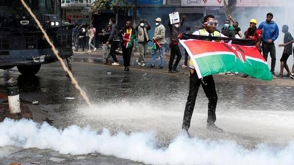 <div class="paragraphs"><p>A demonstrator holds a Kenyan flag as police use water cannons and tear gas to disperse protesters during a demonstration against Kenya's proposed finance bill 2024/2025 in Nairobi, Kenya, June 25, 2024.</p></div>