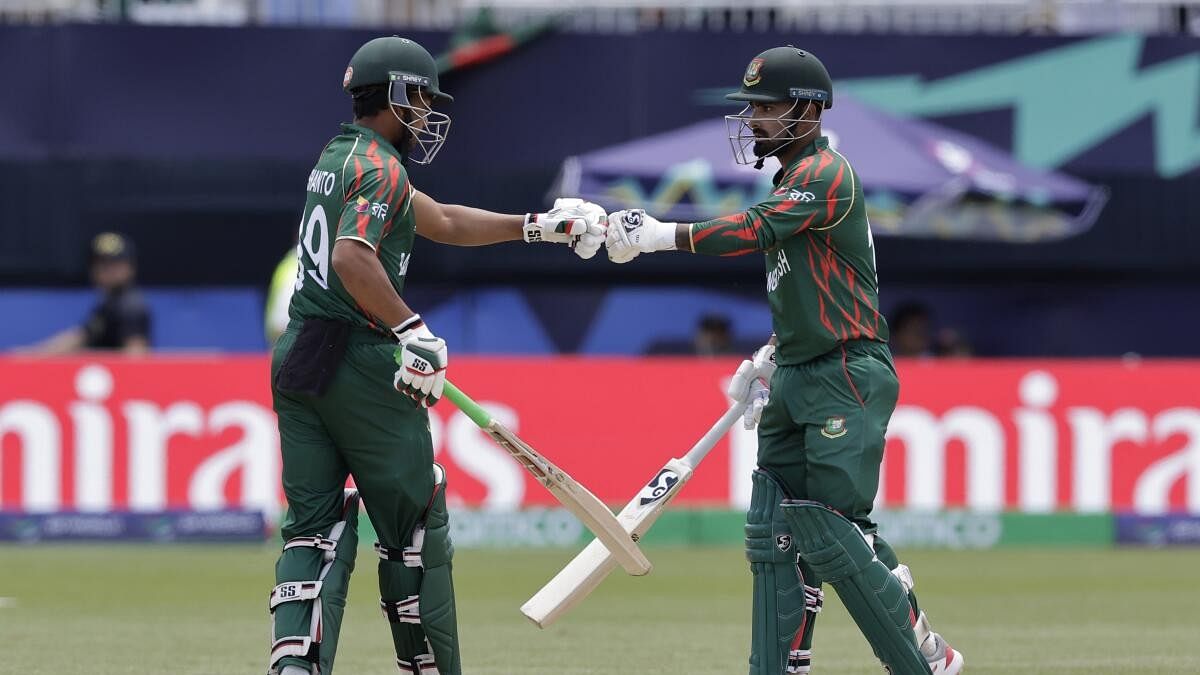 <div class="paragraphs"><p>Bangladesh's captain Najmul Hossain Shanto, left, fist bumps with batting partner Litton Das after hitting a six during the ICC Men's T20 World Cup cricket match between Bangladesh and South Africa at the Nassau County International Cricket Stadium in Westbury.</p></div>