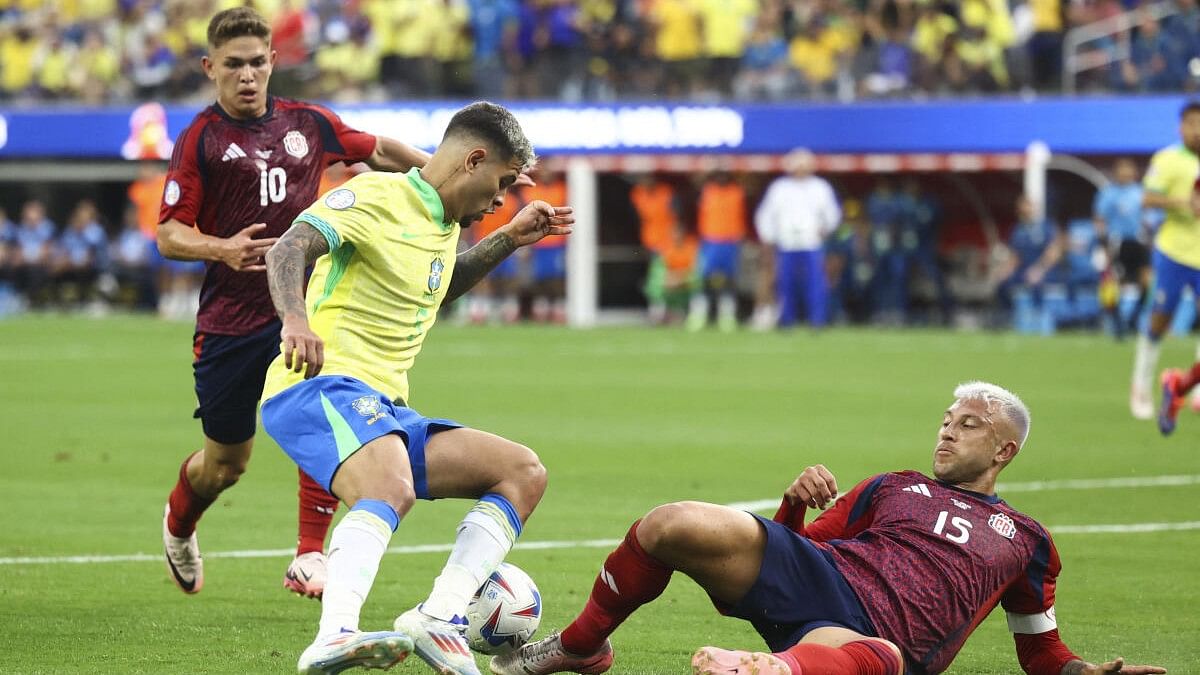 <div class="paragraphs"><p>Costa Rica defender Francisco Calvo (15) slides for a tackle against Brazil midfielder Bruno Guimarães (5) during the first half of a match at SoFi Stadium.</p></div>