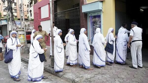 <div class="paragraphs"><p>Nuns wait in a queue to cast their votes at a polling booth during the seventh and last phase of Lok Sabha elections, in Kolkata, Saturday, June 1, 2024.</p></div>