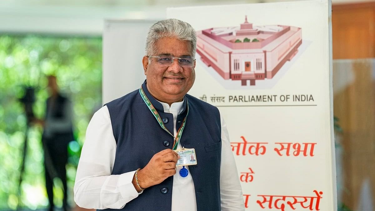 <div class="paragraphs"><p>BJP MP Bhupender Yadav shows his ID Card after the registration process of newly elected members of 18th Lok Sabha at the parliament, in New Delhi.</p></div>