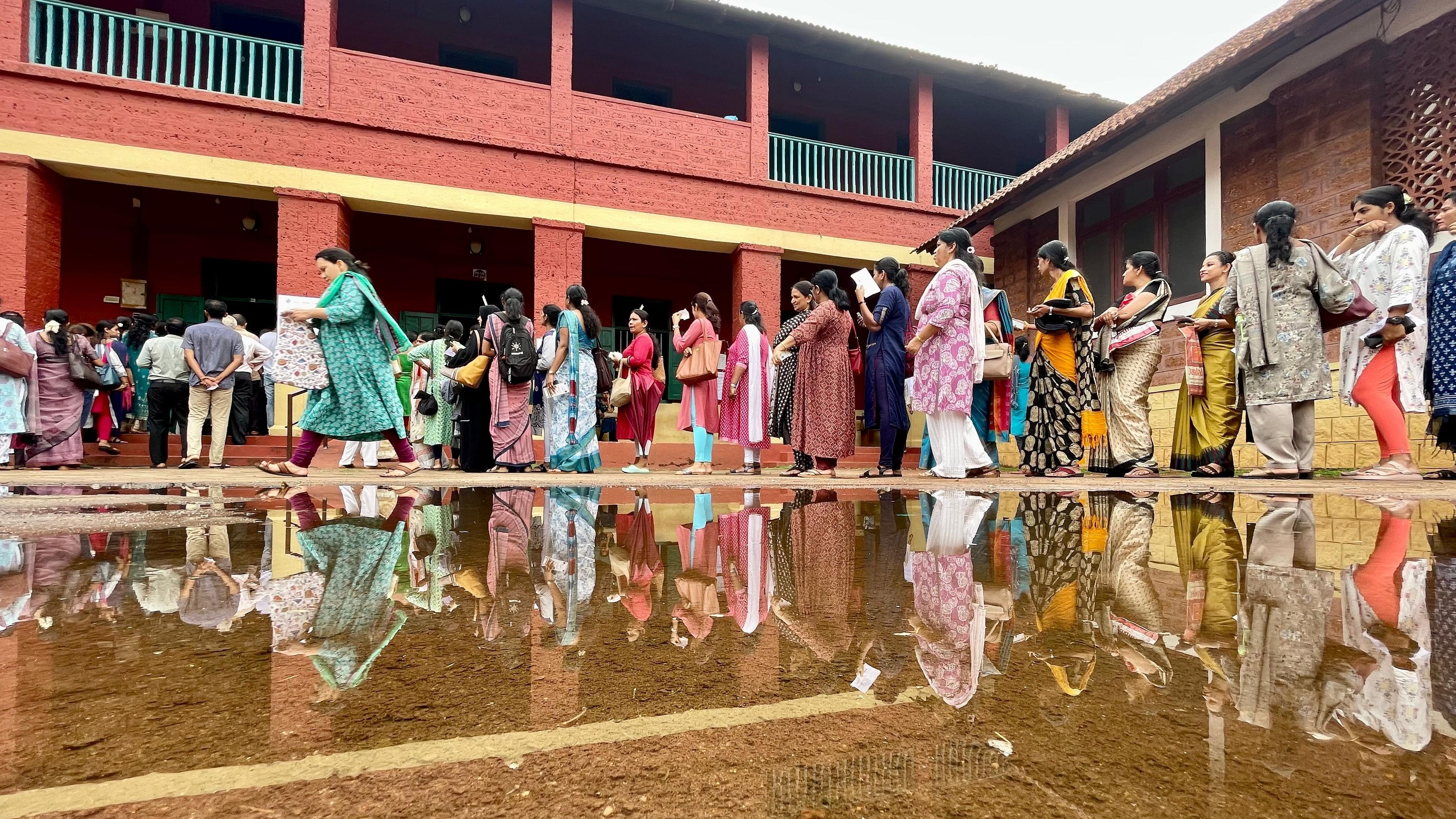 <div class="paragraphs"><p>Voters stand in a queue to cast their votes in South West Graduates and Teachers' constituencies, at University College in Mangaluru on Monday. </p></div>