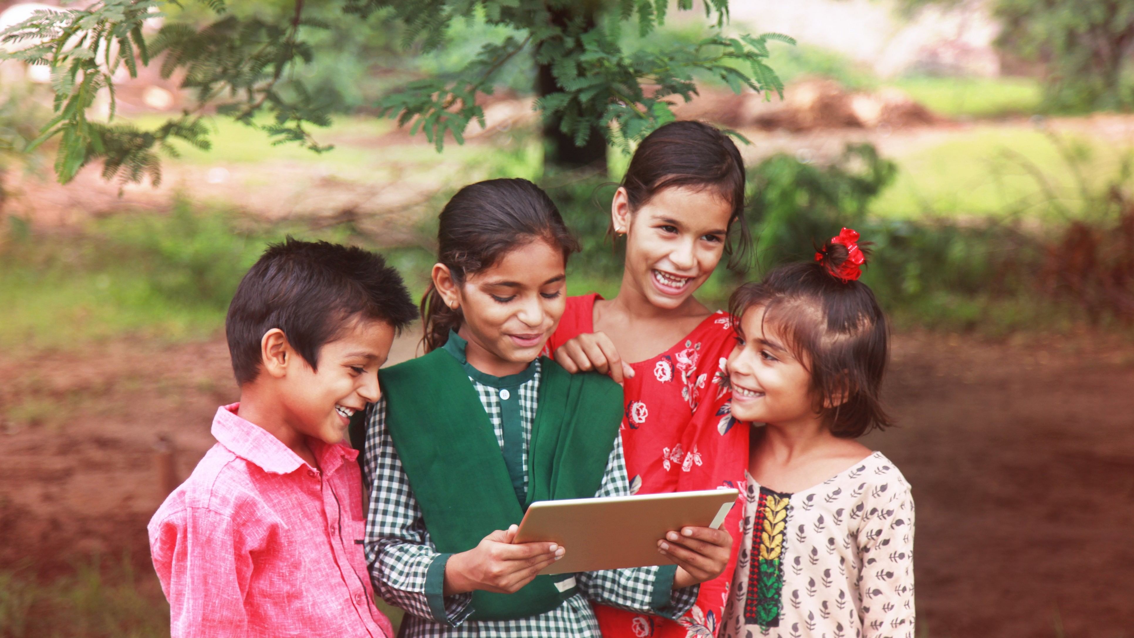 <div class="paragraphs"><p>Rural group of children enjoying digital tablet outdoor nature.</p></div>