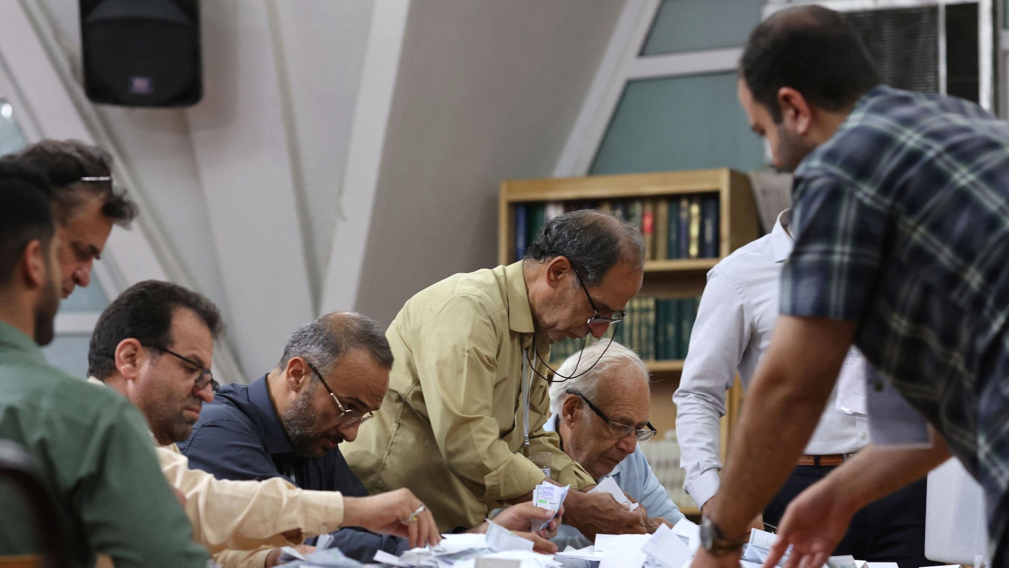 <div class="paragraphs"><p>Electoral staff count ballots in a polling station after voting ended, in a snap presidential election to choose a successor to Ebrahim Raisi following his death in a helicopter crash, in Tehran, Iran June 29, 2024.</p></div>