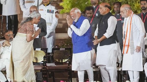 <div class="paragraphs"><p>JP MP Nirmala Sitharaman greets PM Narendra Modi and party leaders Rajnath Singh and Amit Shah at the swearing-in ceremony of new Union government, at Rashtrapati Bhavan in New Delhi.</p></div>