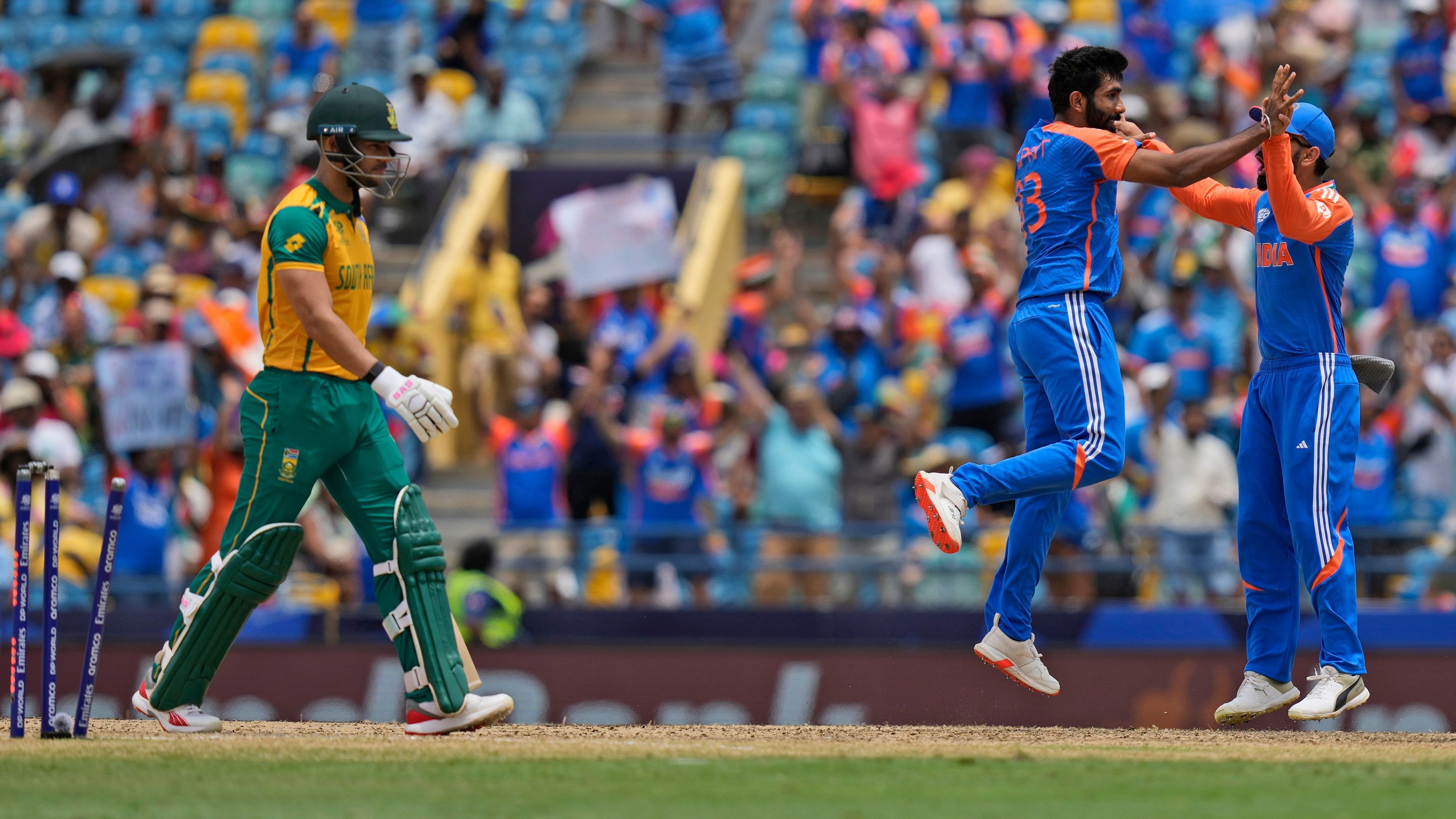 <div class="paragraphs"><p>South Africa's Reeza Hendricks, left, is bowled out by India's Jasprit Bumrah, centre, during the ICC Men's T20 World Cup final cricket match between India and South Africa at Kensington Oval in Bridgetown, Barbados, Saturday, June 29, 2024. </p></div>