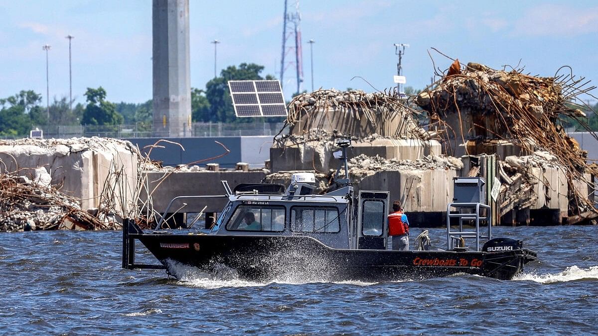 <div class="paragraphs"><p>File photo of a small boat cruises past the clean-up operations at the Francis Scott Key Bridge as the main shipping channel prepares to fully reopen, in Baltimore, Maryland, US, June 10, 2024.</p></div>