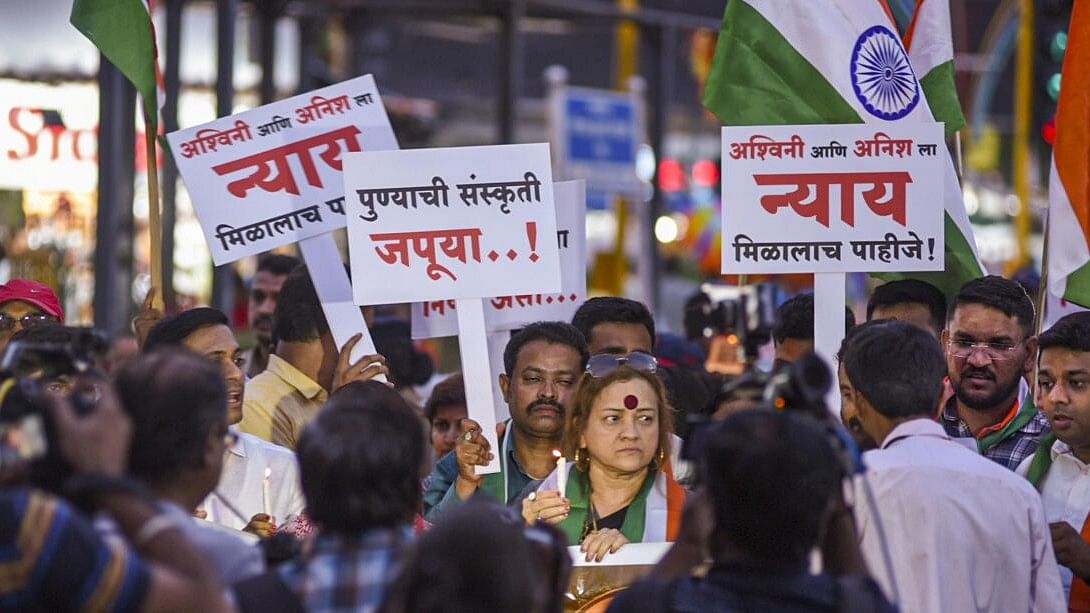 <div class="paragraphs"><p>People take part in a candlelight vigil march to pay condolences to motorbikers who were killed after being knocked down by a porsche car, in Pune.</p></div>