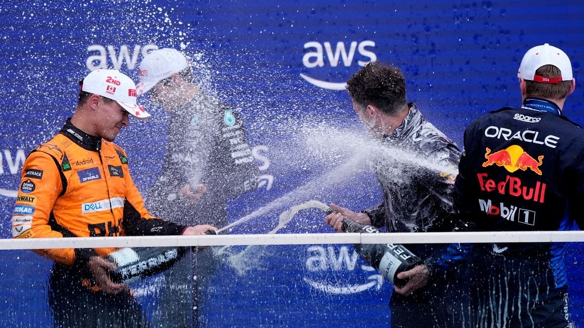 <div class="paragraphs"><p>Red Bull's Max Verstappen celebrates on the podium after winning the Canadian Grand Prix alongside second place McLaren's Lando Norris and third place Mercedes' George Russell.</p></div>