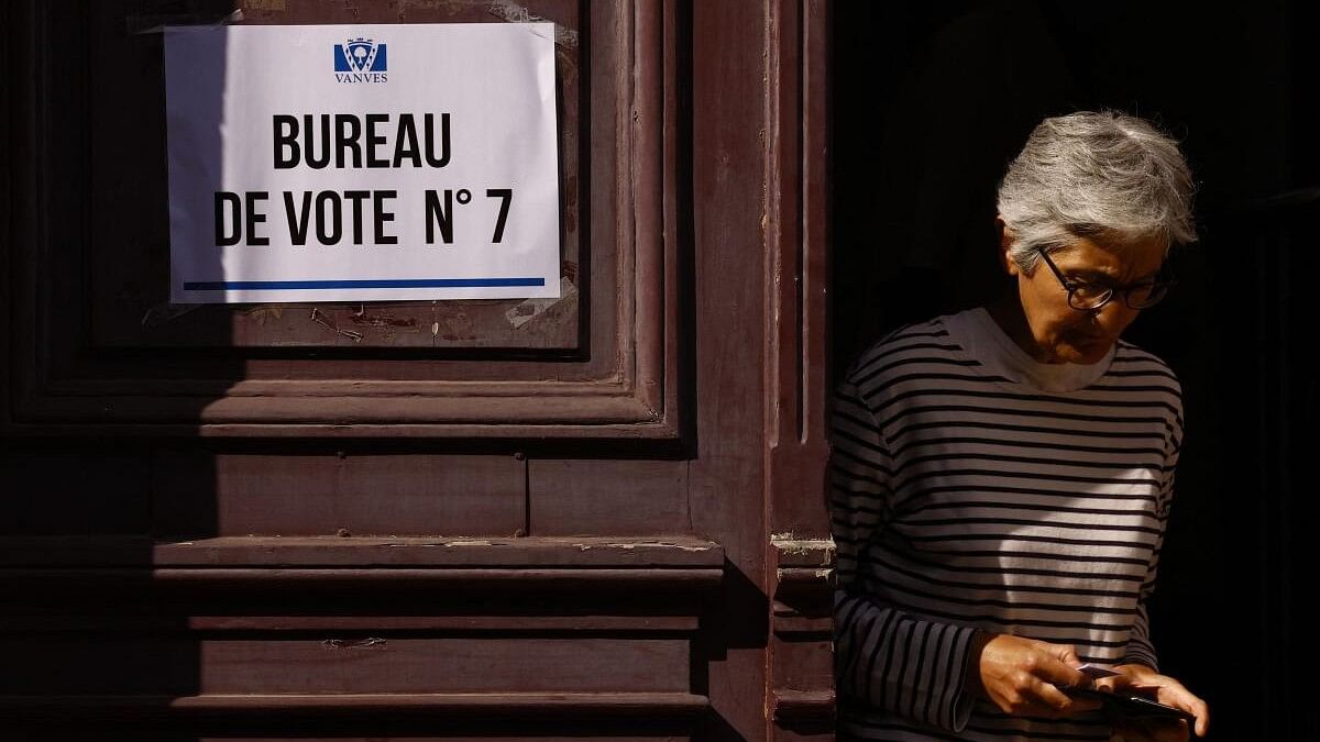 <div class="paragraphs"><p>A voter leaves a polling station after voting in the first round of the early French parliamentary elections, in Vanves near Paris, France, June 30, 2024.</p></div>