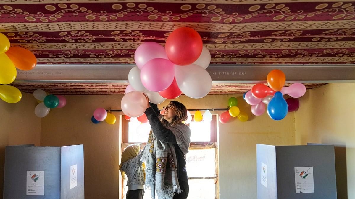 <div class="paragraphs"><p> Tourist Gaia Raba and first-time voter Lanzom, background, decorate the world's highest polling station on the eve of the last phase of Lok Sabha elections, at Tashigang village in Spiti Valley, Friday, May 31, 2024. </p></div>