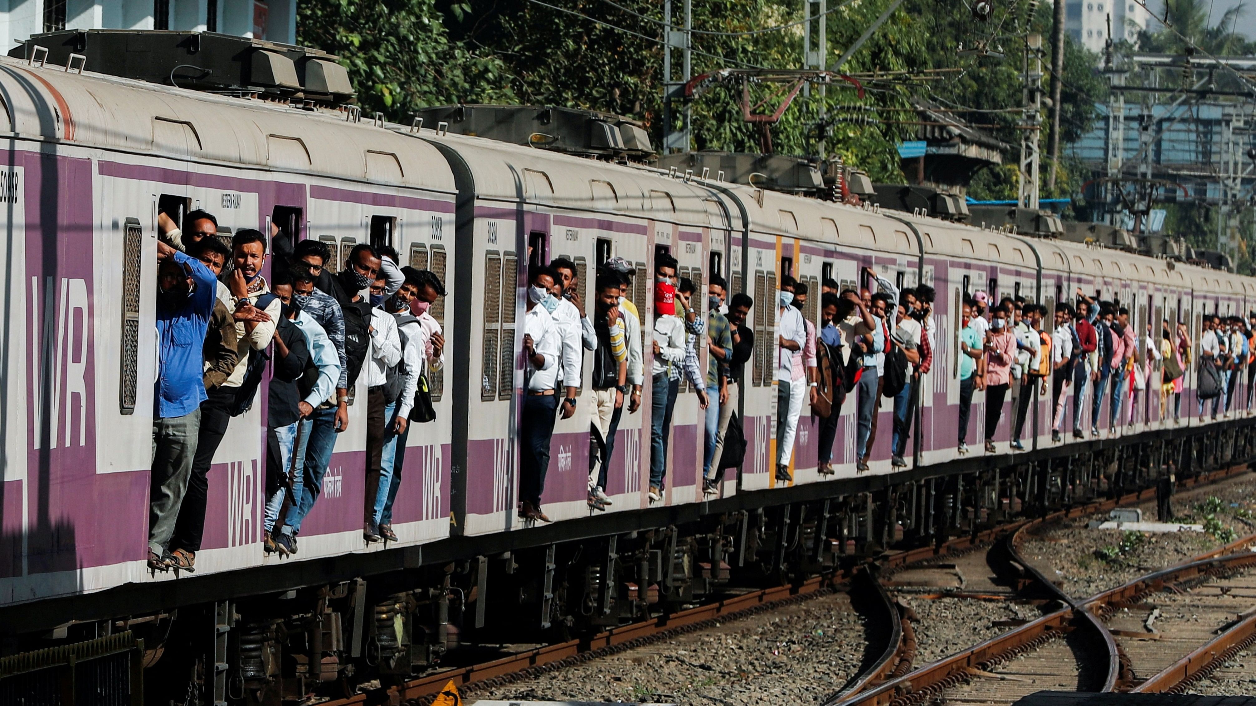 <div class="paragraphs"><p>Commuters travel in a train in Mumbai.</p></div>
