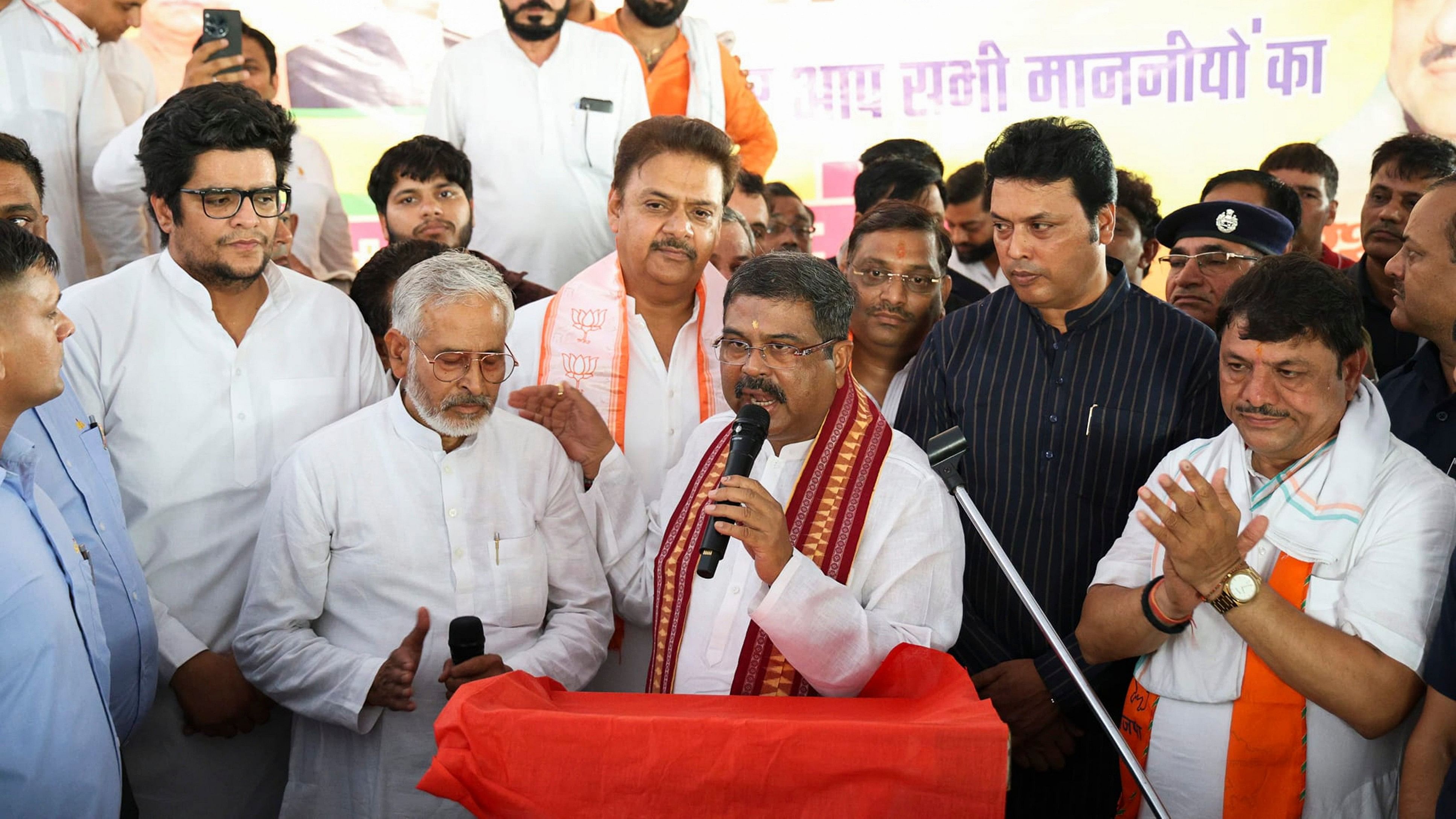 <div class="paragraphs"><p>Union Minister Dharmendra Pradhan and MP Biplab Kumar Deb being welcomed by BJP workers upon their arrival, in Bahadurgarh.</p></div>